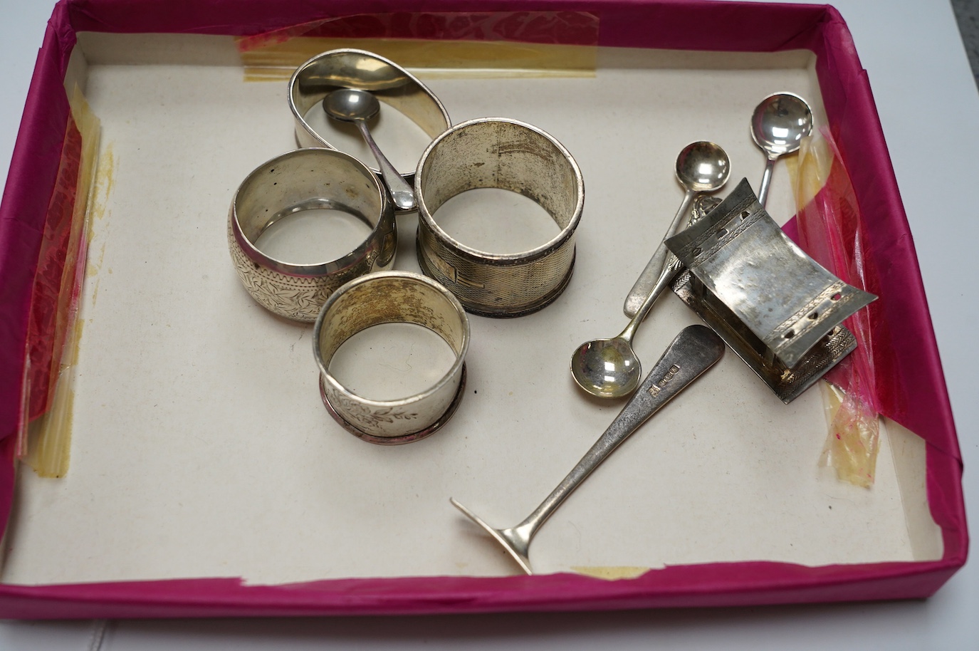 Sundry small silver including five silver napkin rings, and 800 napkin ring, a Victorian silver mustard and salt, an Egyptian small white metal dish, three silver condiment spoons and five plated items. Condition - poor